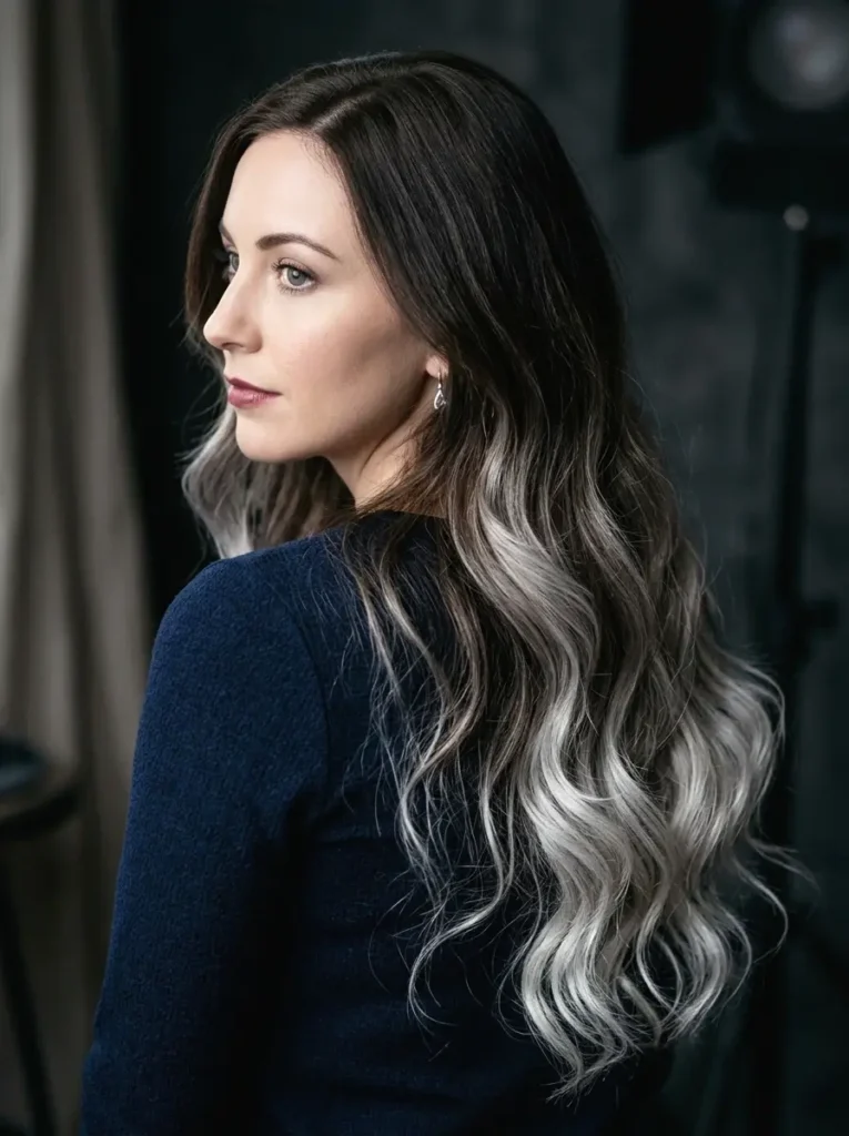 Woman with espresso brown hair and soft silver ombre showing dark to silver color transition