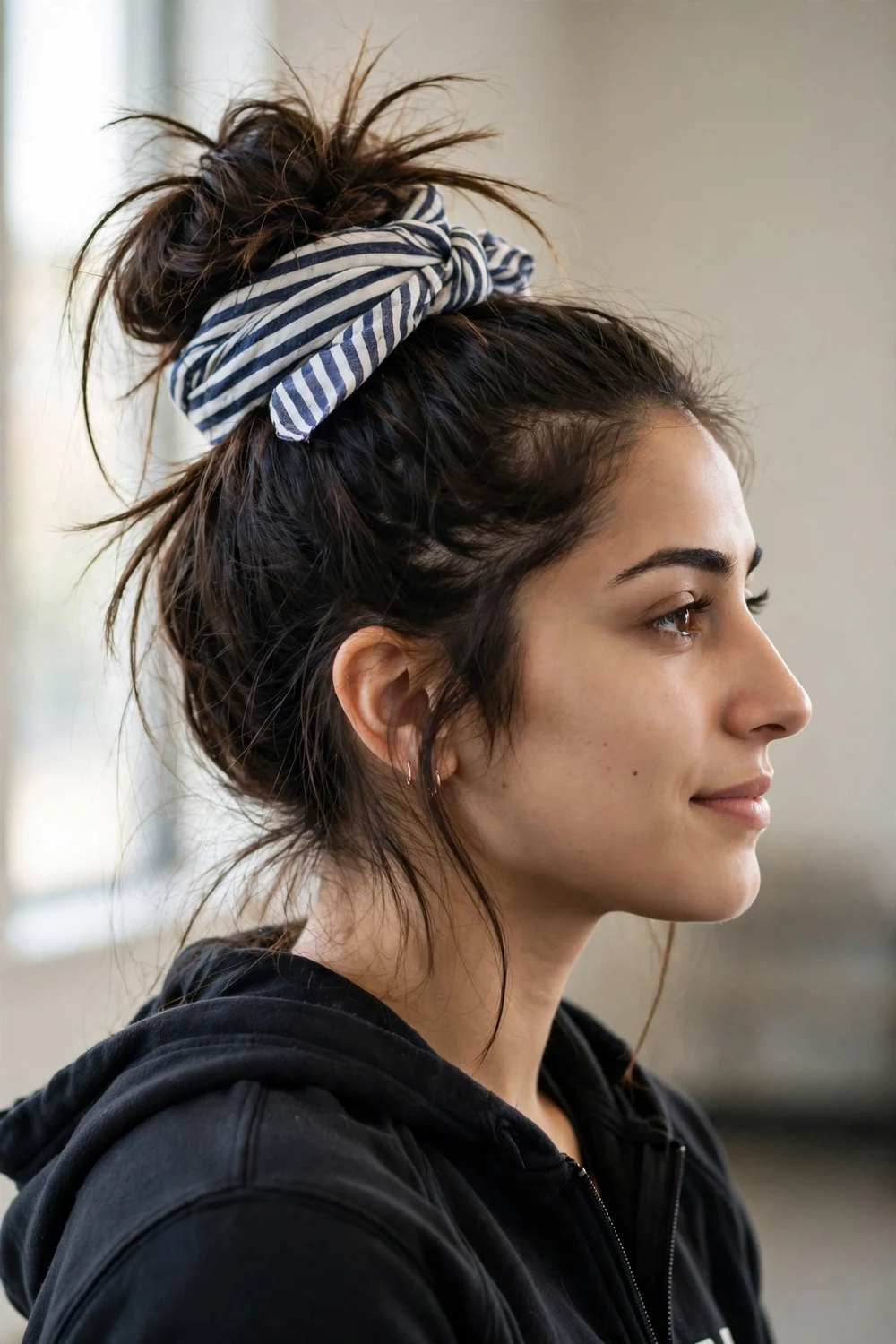Woman with messy bun and striped hair wrap