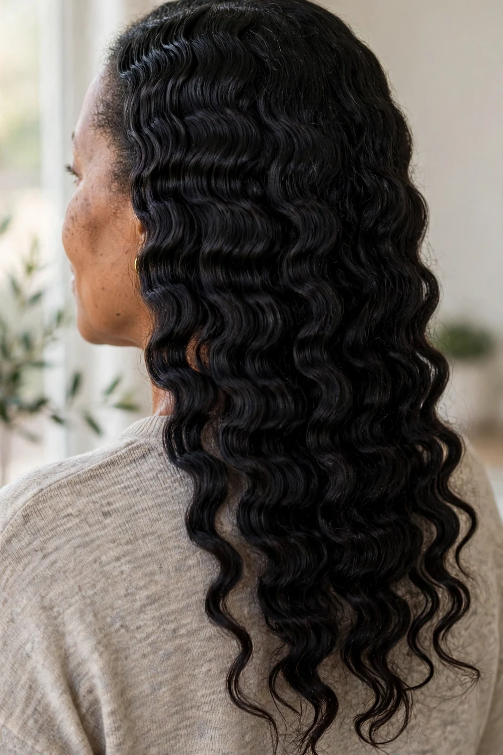 Black woman with a soft wavy 4A braid-out showing stretched crimped texture