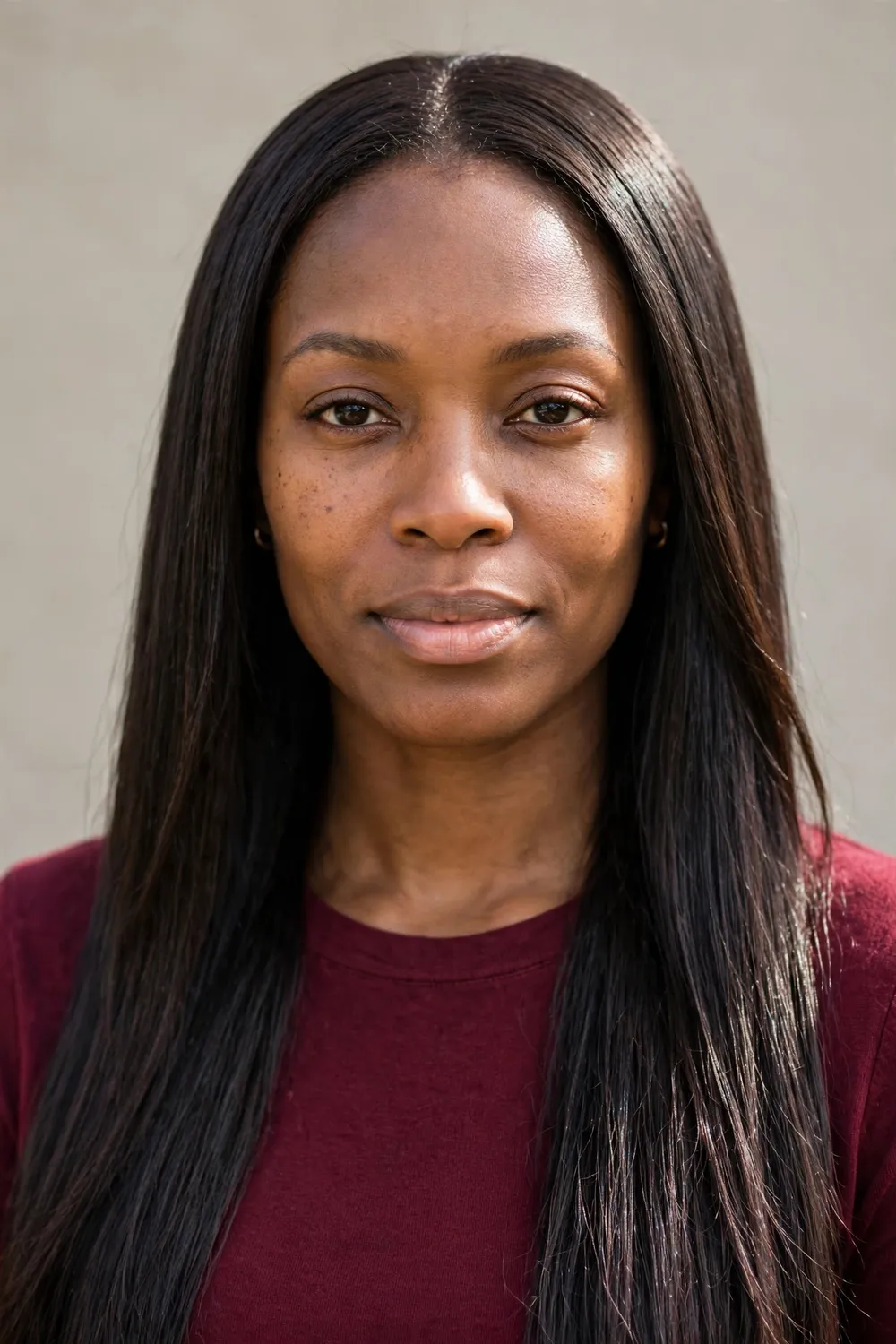 Black woman with long espresso brown hair styled sleek and straight