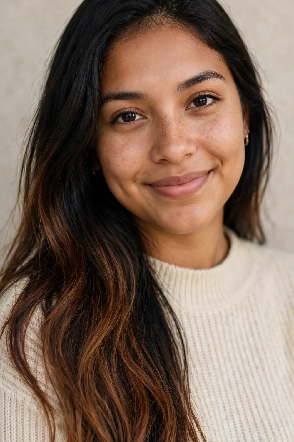 Hispanic woman with long black hair melting into a warm medium-brown ombre