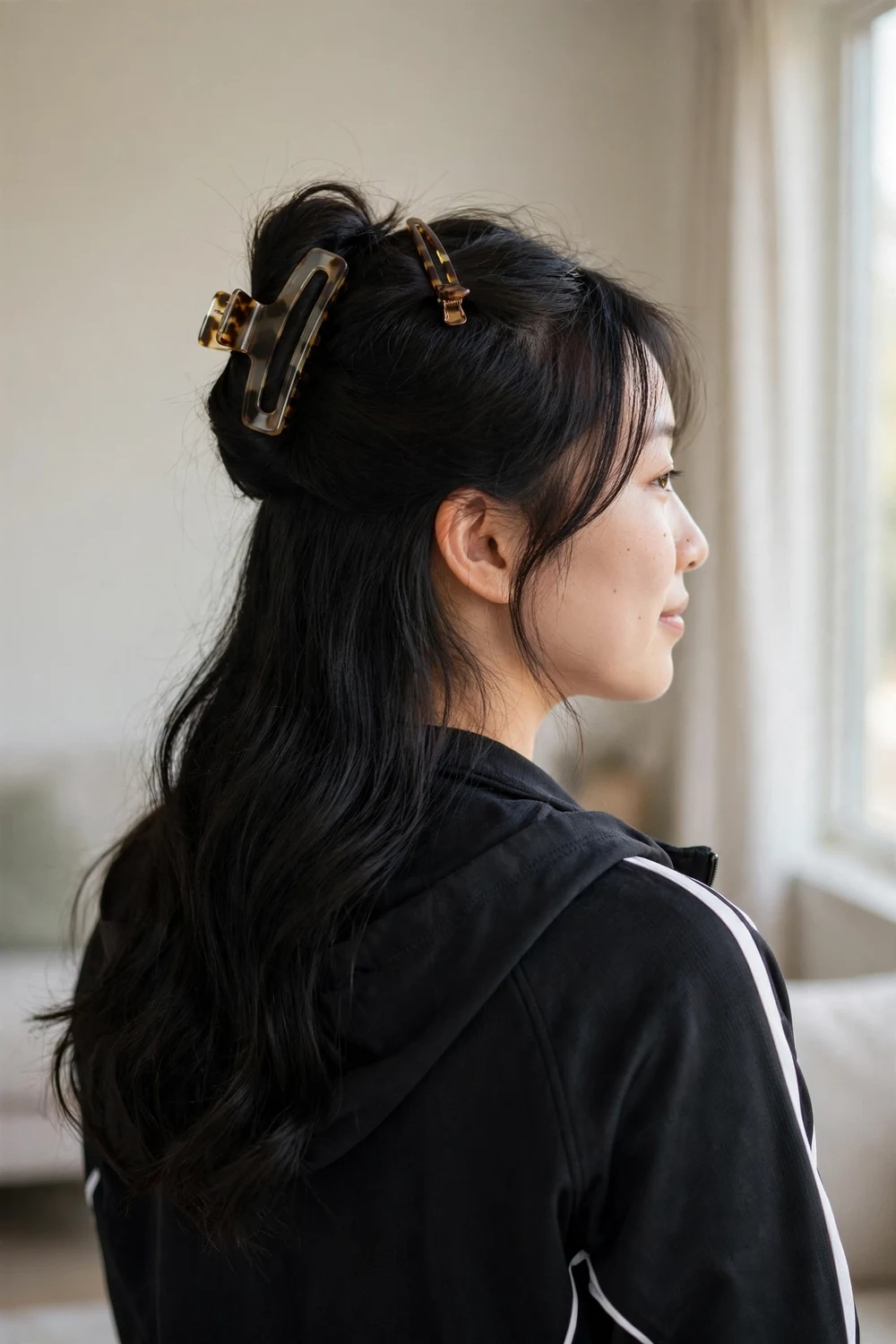 Woman with half-up half-down hair secured with clips for basketball
