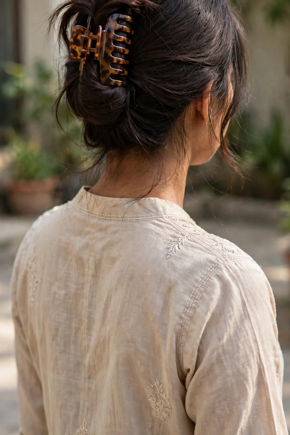 Woman with a twisted updo secured by a large claw clip