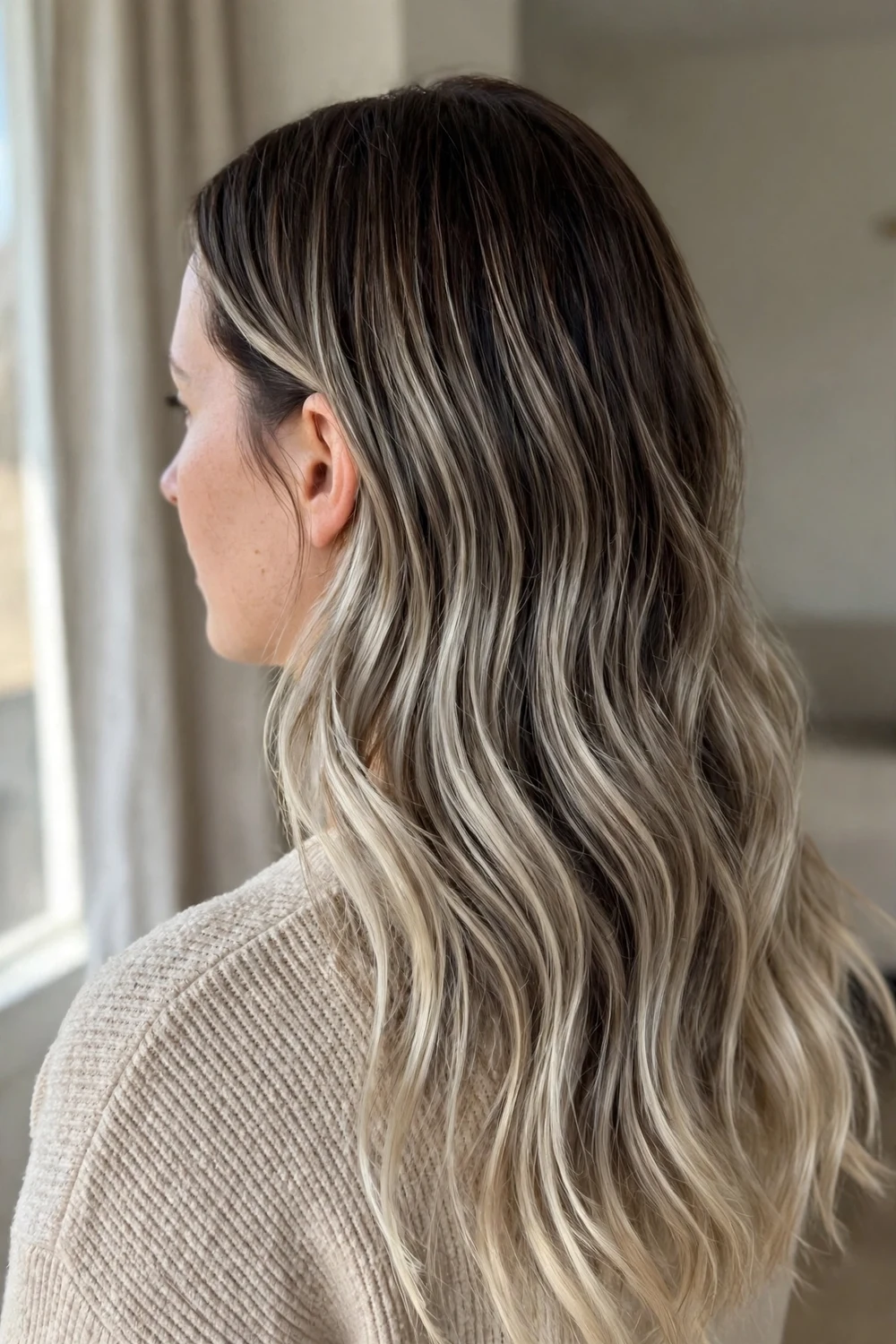 Dimensional cool ash balayage with heavy mid-length highlights on dark hair