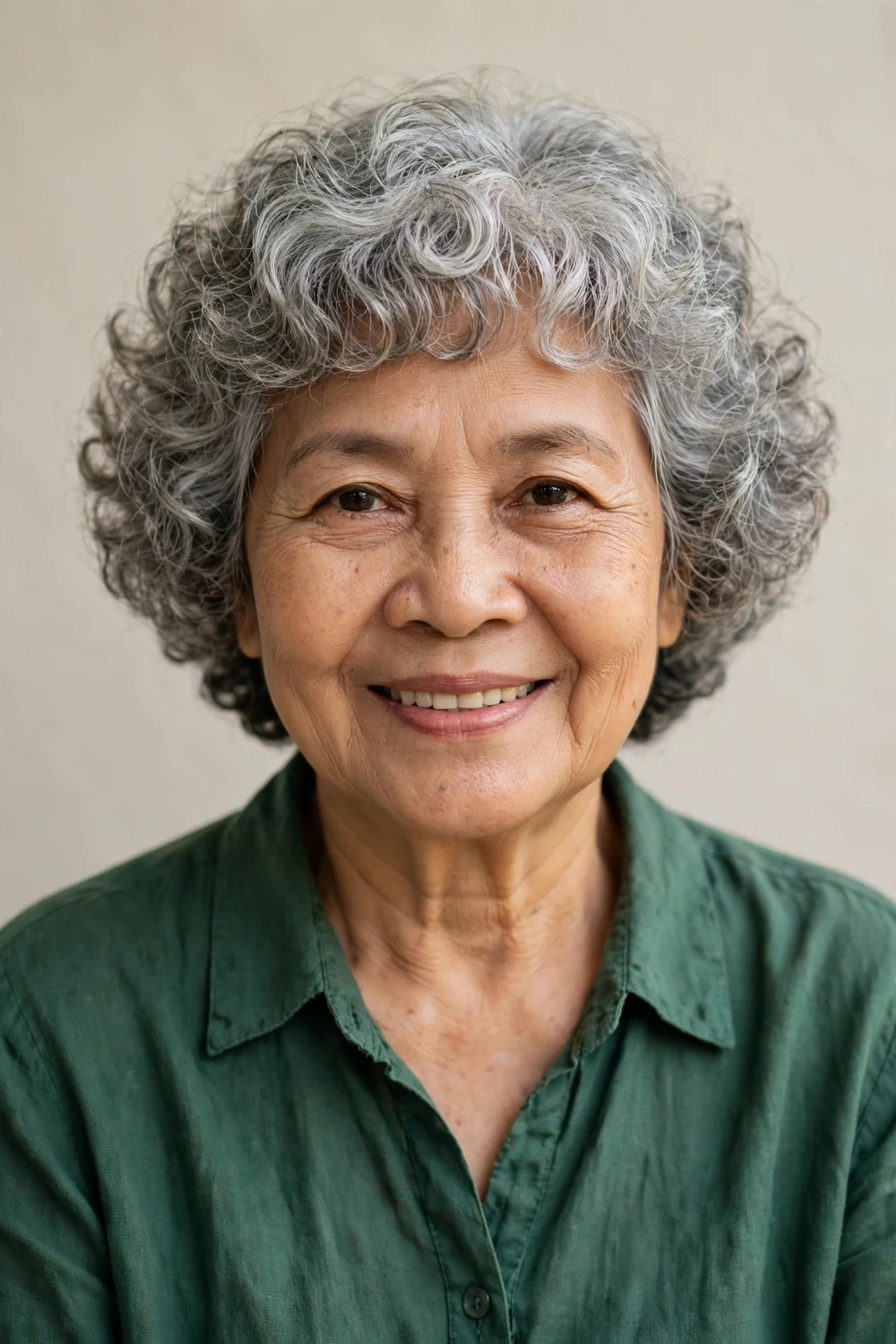 Curly bob with full fringe of cropped curls on woman over 60