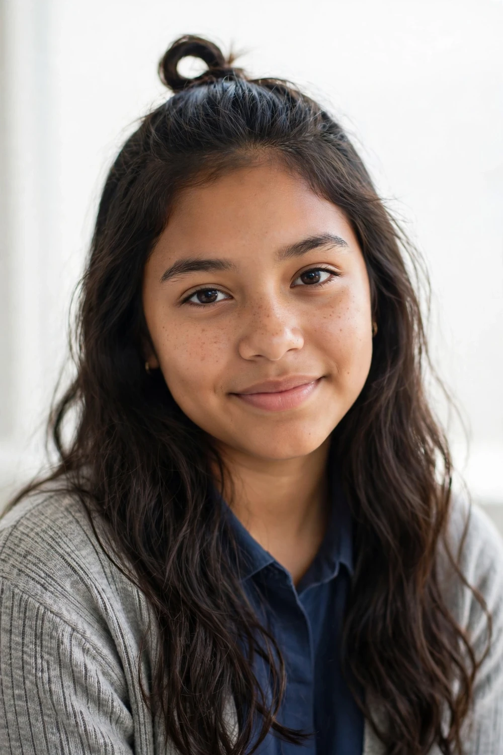 Blonde teen with soft natural waves falling past her shoulders, styled without heat overnight