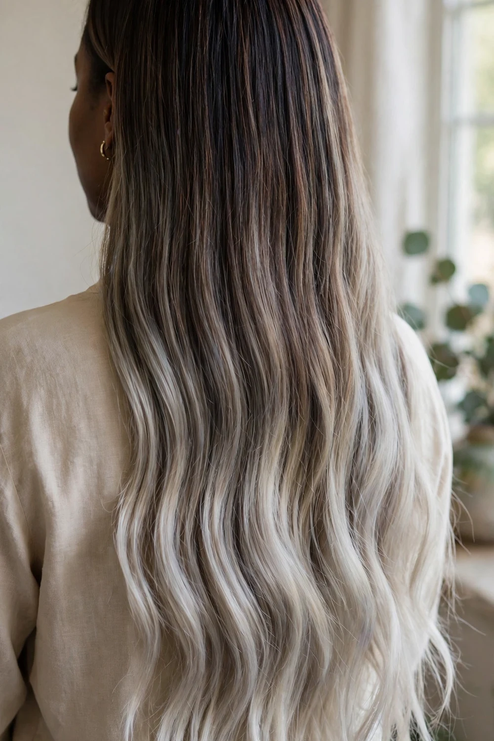 Long dark brown hair with a root shadow melt fading into icy ash blonde ends