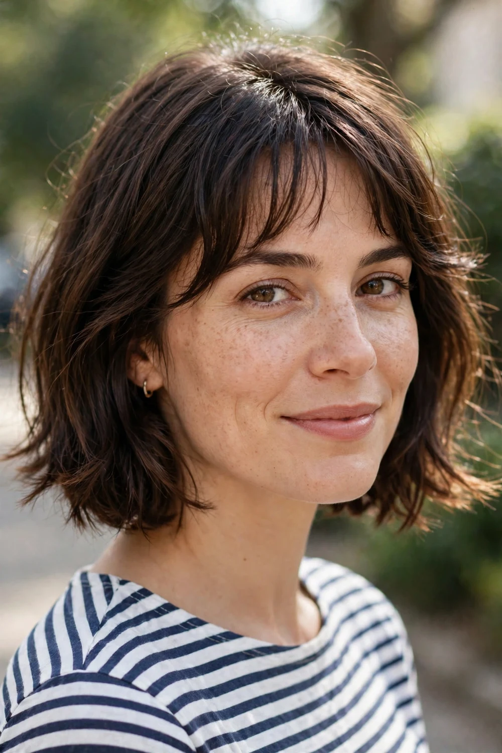 Woman with a French bob haircut with chin length and soft bangs