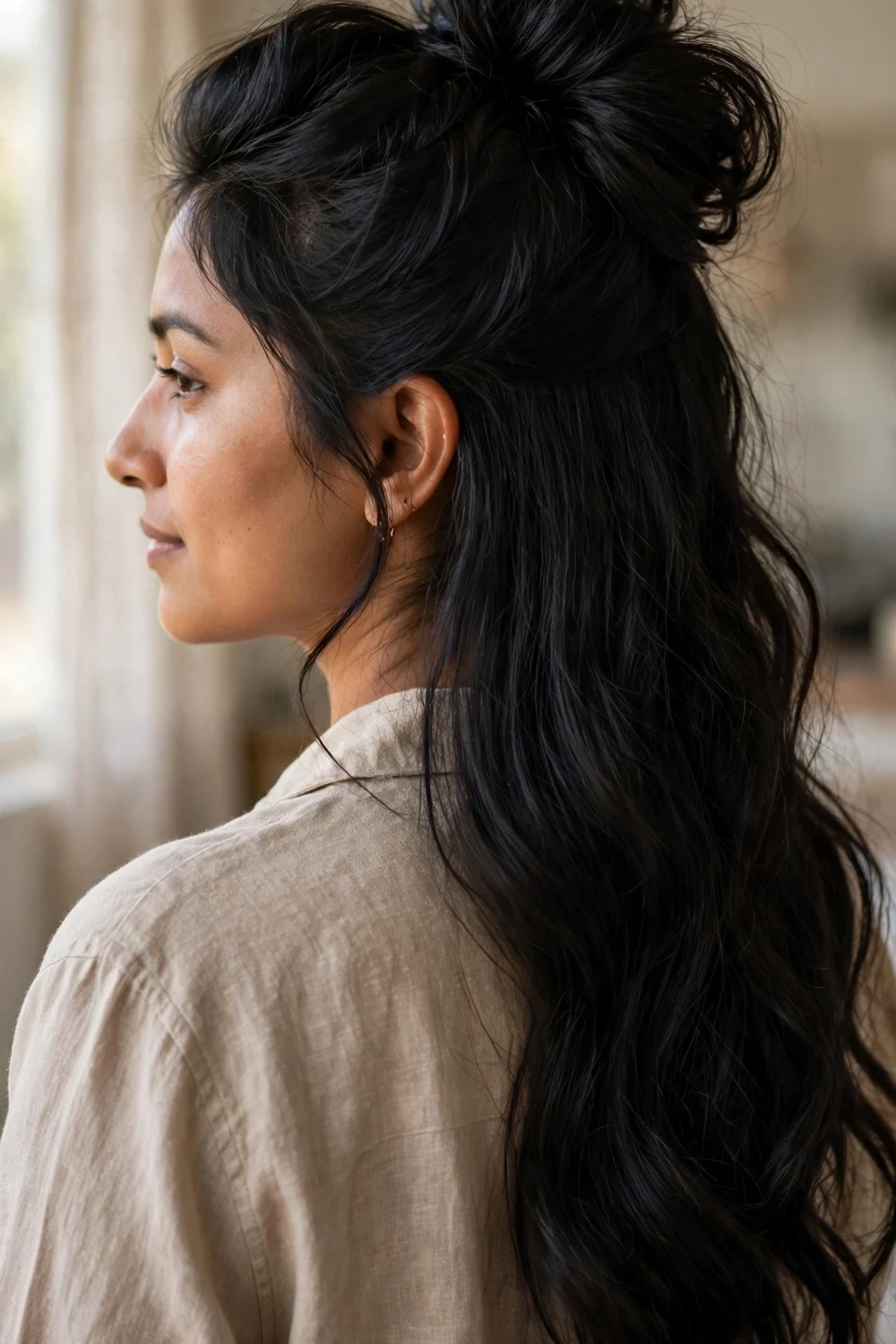 Woman with half up hairstyle with crown volume for Christmas long hair