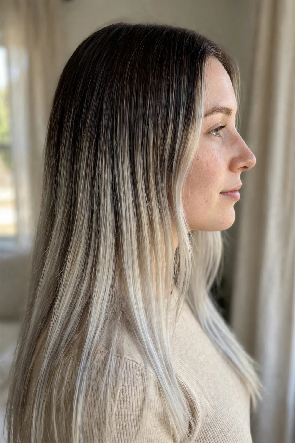 Long straight dark hair with cool-toned icy blonde balayage toward the ends