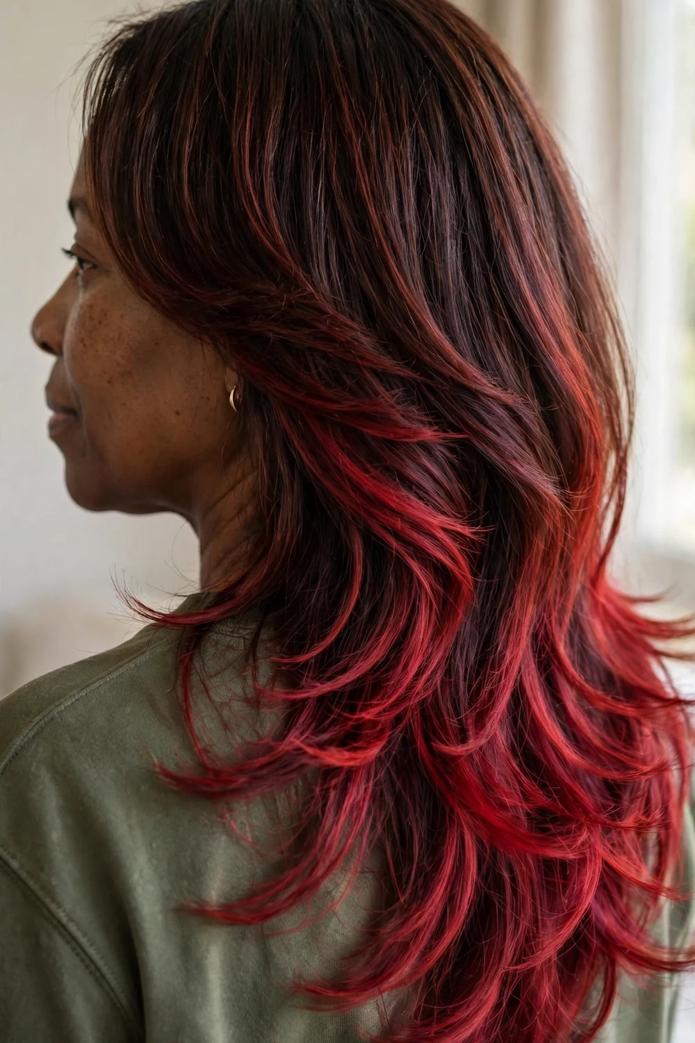 Long layered dark hair with cherry cola color melted from mid-lengths to ends
