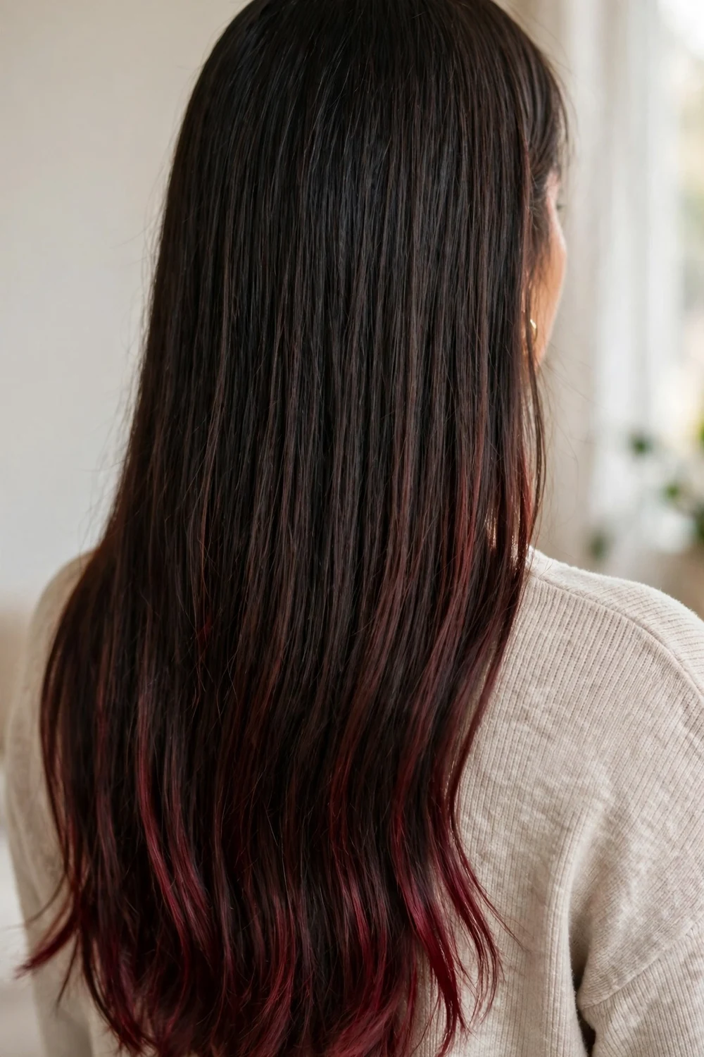 Long straight dark hair with cherry burgundy tones on the bottom third