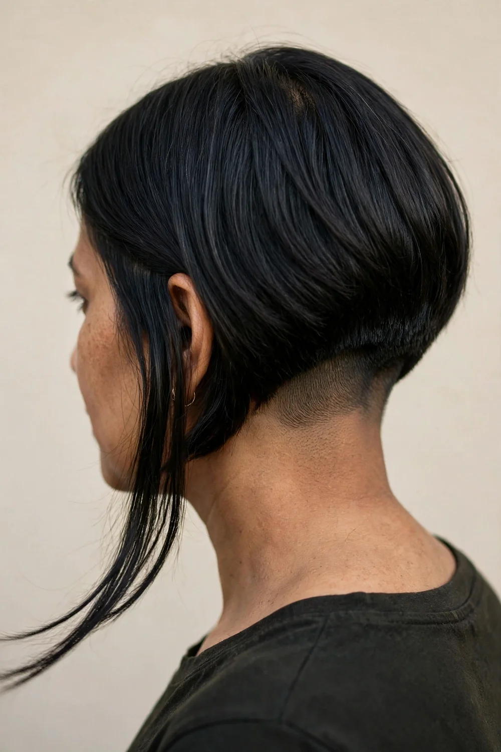 Inverted bob with a nape undercut, longer top layers covering the shaved neckline
