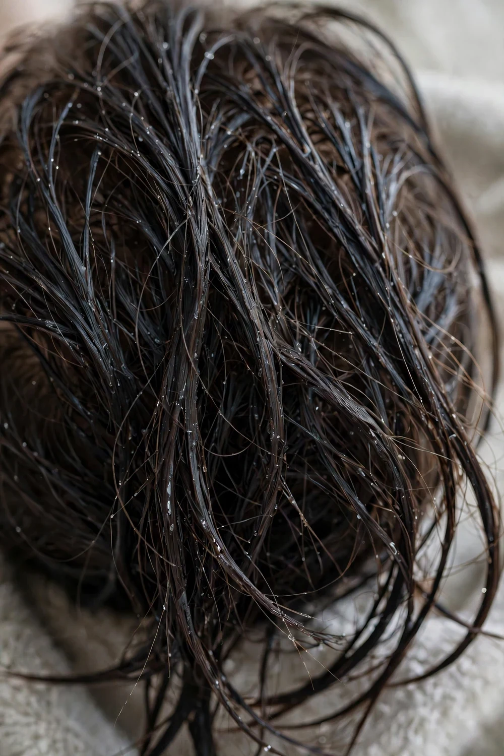 Close-up of limp over-moisturized hair lacking volume after too much steaming