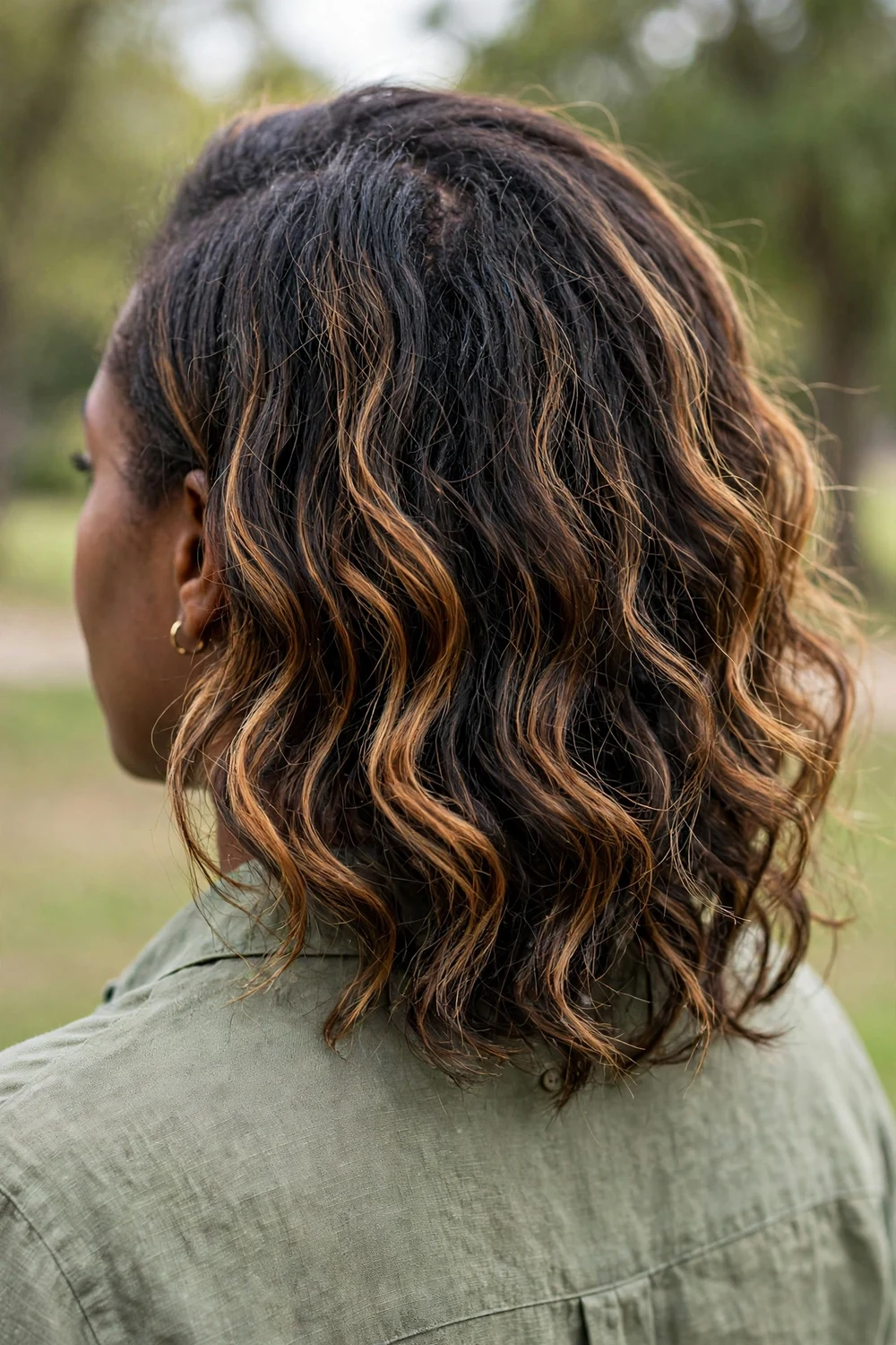 Woman showing soft natural regrowth with partial highlights