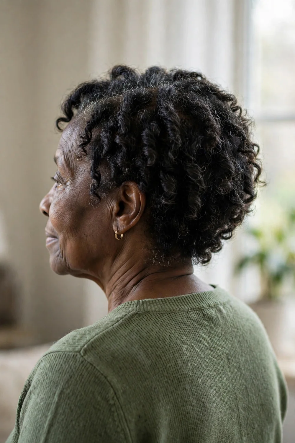 Older woman with a short afro-inspired curly cut