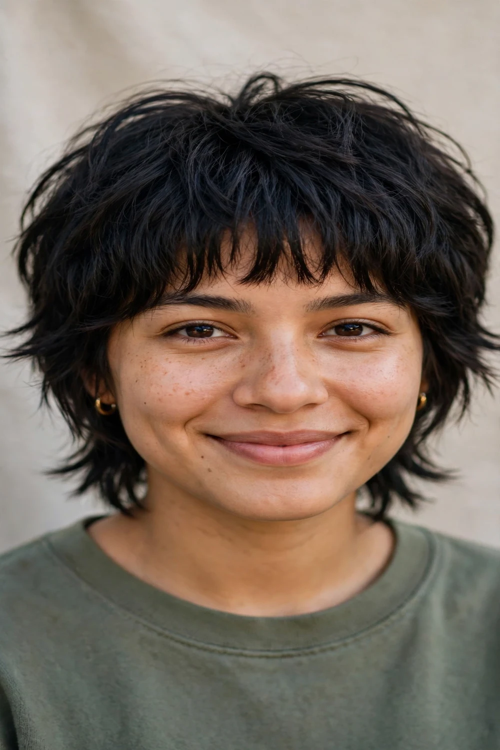Woman with a short shag haircut and full textured fringe