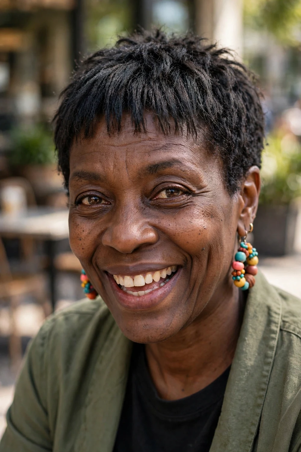 Older Black woman with a textured crop and micro bangs