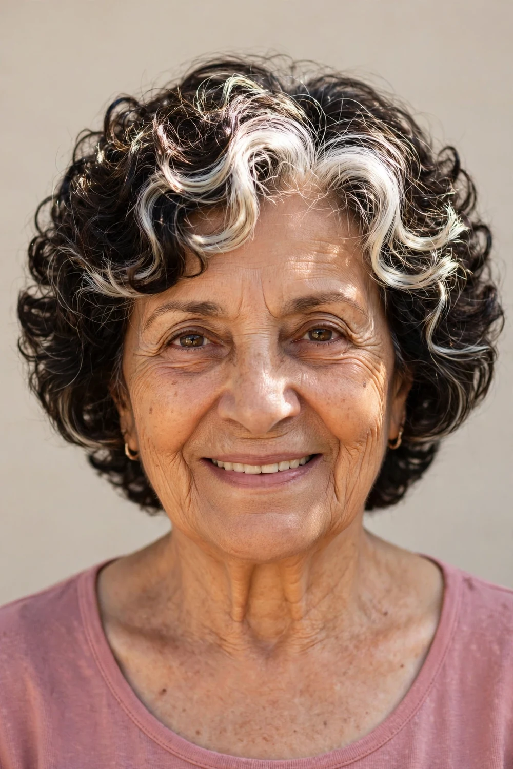 Wedge bob with platinum highlights in silver curls on older woman