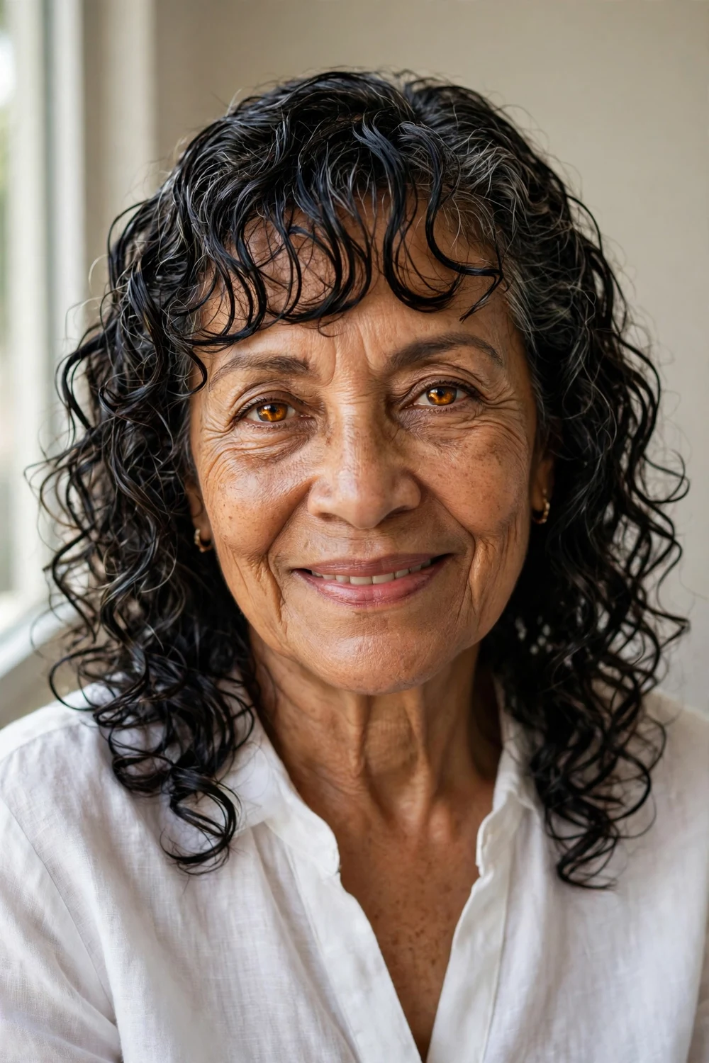 Wet-look glossy defined curls with piecey fringe on mature woman